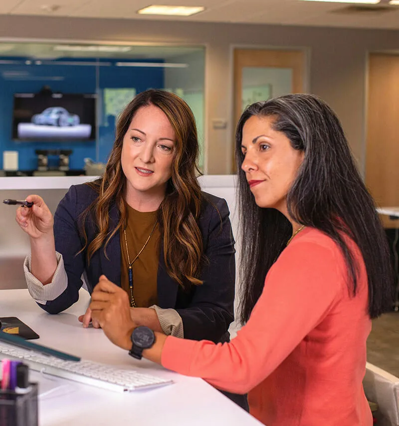 Two women discussing project