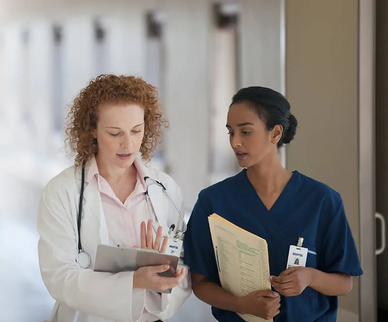 Nurse and doctor walking in hallway