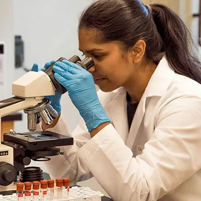 Woman looking in microscope